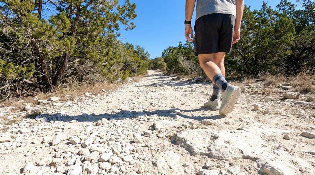 Hiker applying blister prevention tape before mountain trek